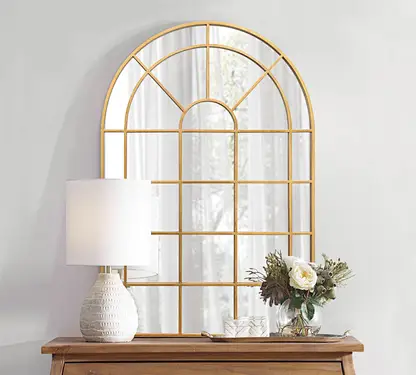 Gold-framed windowpane mirror in close up view - Reflective space partition with ambient lighting integration